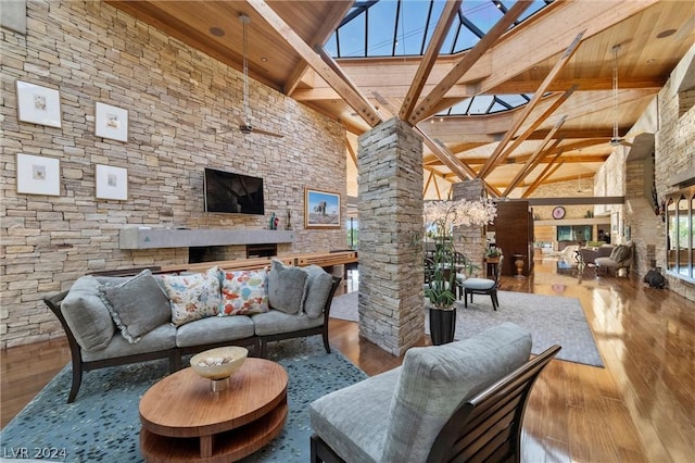 interior space featuring high vaulted ceiling, wood ceiling, wood-type flooring, and decorative columns