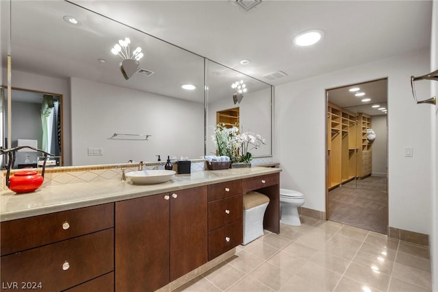 bathroom featuring vanity, tile patterned floors, and toilet