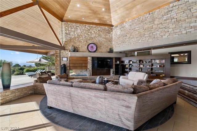 tiled living room with wood ceiling and a high ceiling