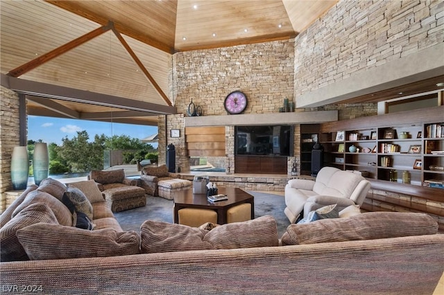 interior space featuring a high ceiling, wooden ceiling, and an outdoor stone fireplace