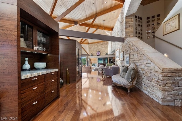 interior space featuring hardwood / wood-style flooring, wood ceiling, beam ceiling, and high vaulted ceiling