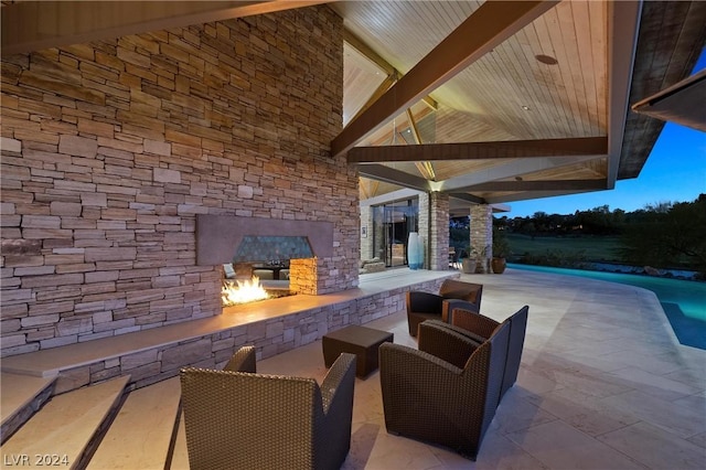 view of patio / terrace featuring an outdoor stone fireplace