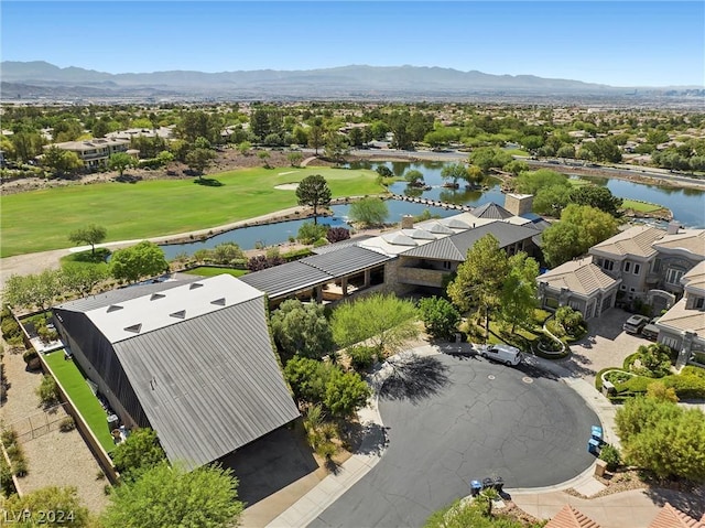 birds eye view of property with a water and mountain view