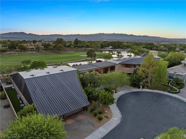 aerial view at dusk featuring a mountain view