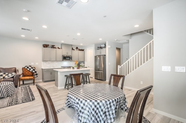 dining area with light hardwood / wood-style floors