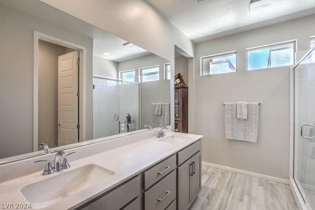 bathroom with vanity and a shower with shower door