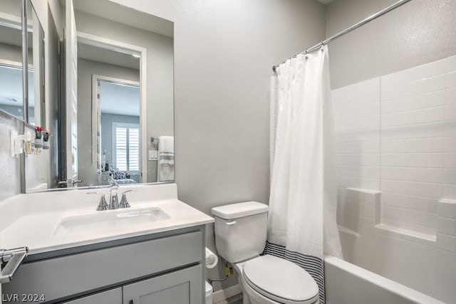 full bathroom featuring vanity, toilet, and shower / tub combo with curtain