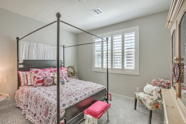 carpeted bedroom featuring multiple windows