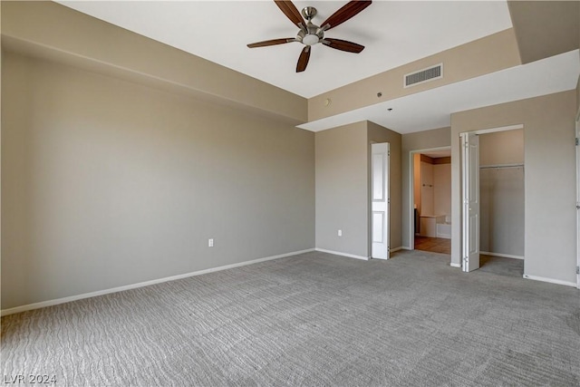 unfurnished bedroom with baseboards, visible vents, a ceiling fan, carpet floors, and a closet