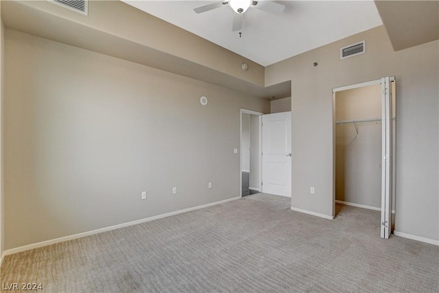 unfurnished bedroom with light colored carpet, a closet, visible vents, and baseboards