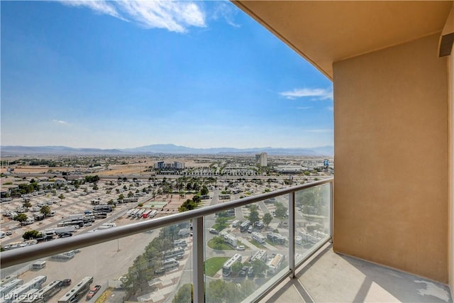 balcony with a mountain view and a city view