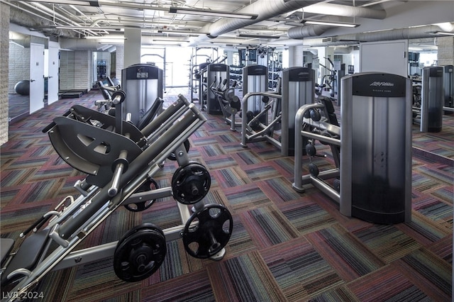 workout area featuring dark colored carpet