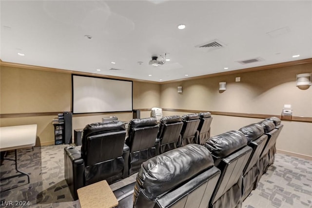 home theater featuring baseboards, visible vents, and crown molding