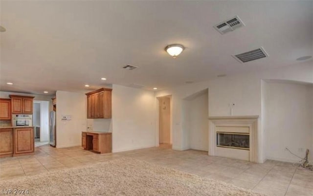 unfurnished living room with light tile patterned flooring