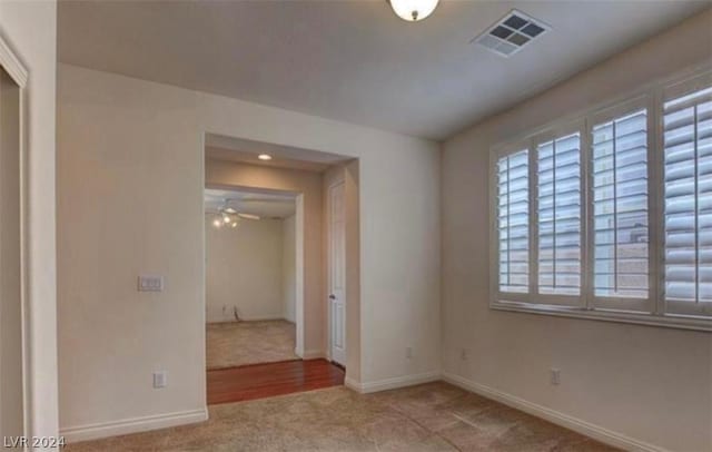 carpeted empty room featuring ceiling fan