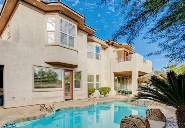 rear view of property with a balcony