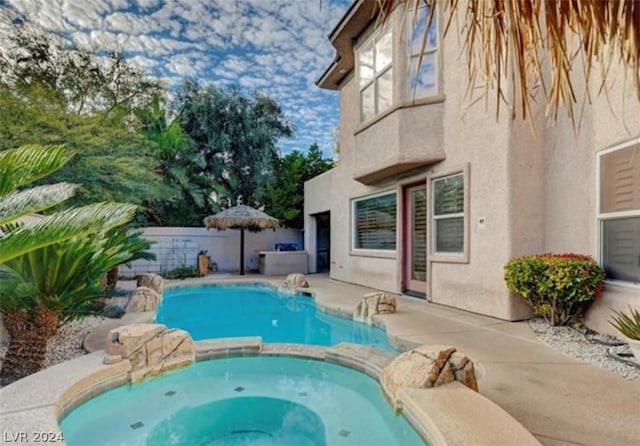 view of swimming pool featuring an in ground hot tub