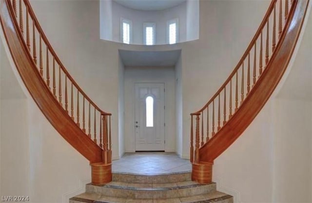 foyer featuring tile patterned flooring and a high ceiling