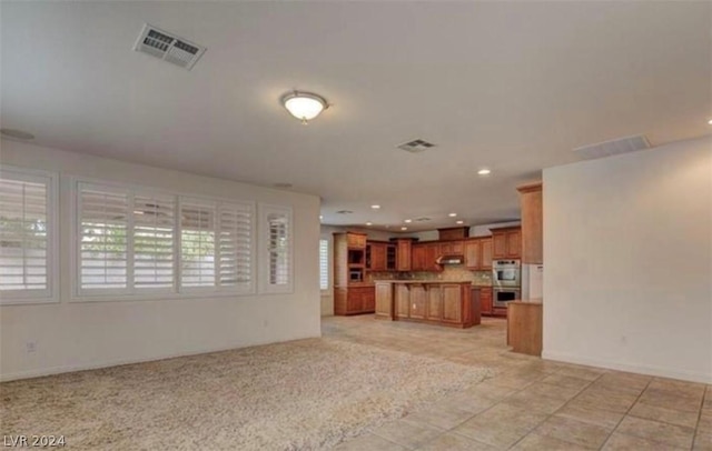 unfurnished living room featuring light tile patterned floors