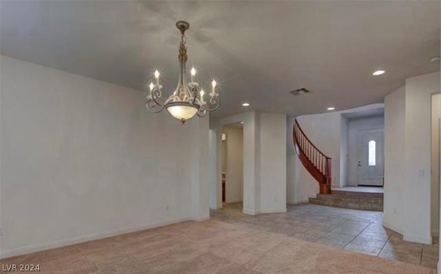 unfurnished room featuring light tile patterned floors and a notable chandelier