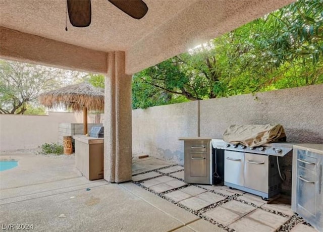 view of patio / terrace featuring area for grilling and ceiling fan