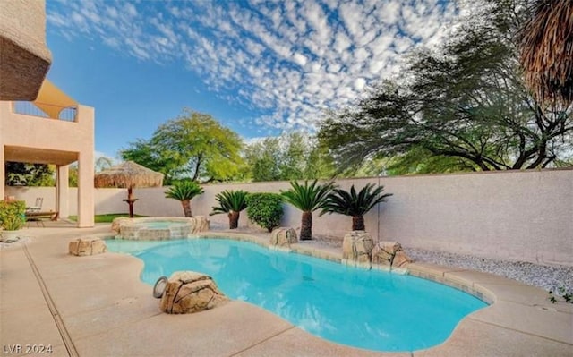 view of swimming pool with a patio area and an in ground hot tub