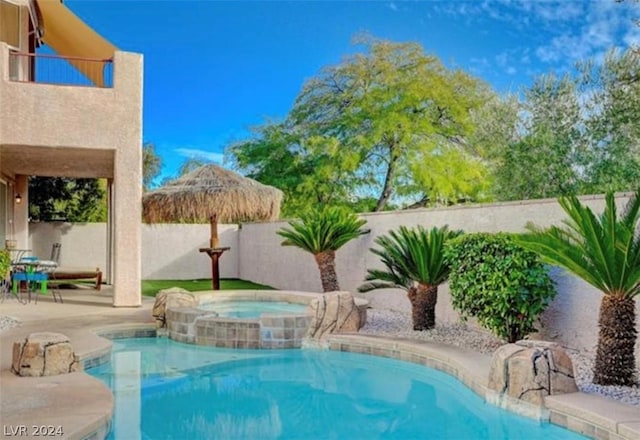 view of pool with an in ground hot tub