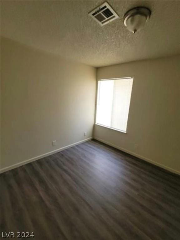 unfurnished room featuring dark hardwood / wood-style floors