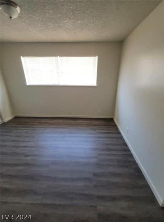 empty room with dark wood-type flooring