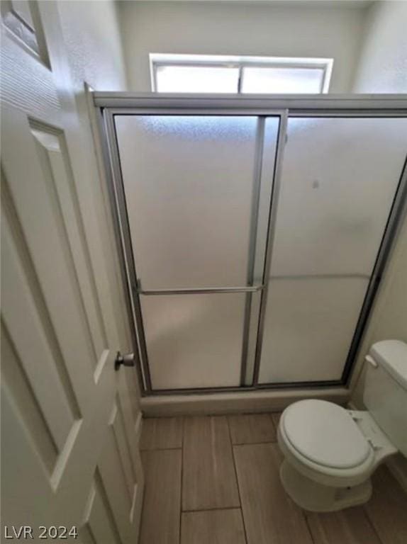 bathroom with toilet and walk in shower