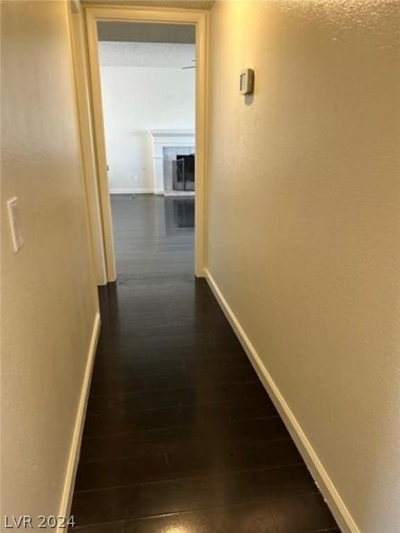 corridor with dark hardwood / wood-style flooring