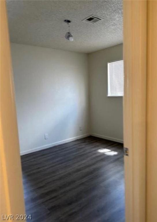 empty room with dark wood-type flooring