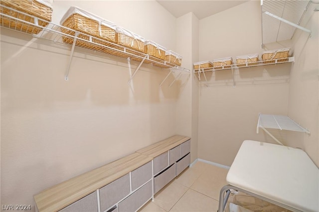 walk in closet featuring light tile patterned flooring