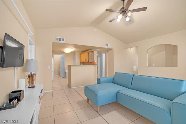 living room with vaulted ceiling, light tile patterned floors, and ceiling fan