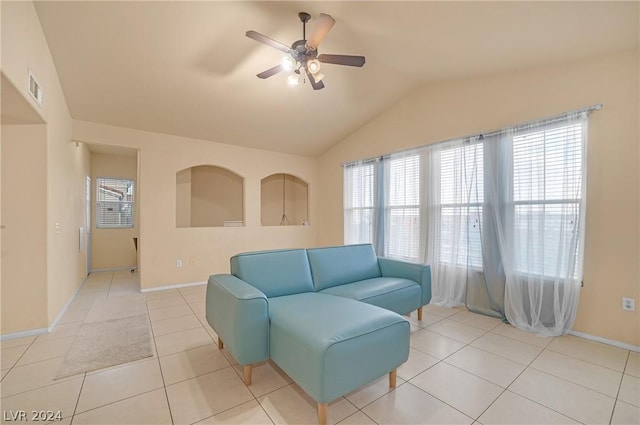 living area with light tile patterned floors, vaulted ceiling, and ceiling fan