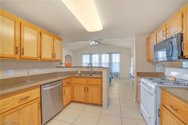 kitchen with sink, vaulted ceiling, light tile patterned floors, white gas range, and dishwasher