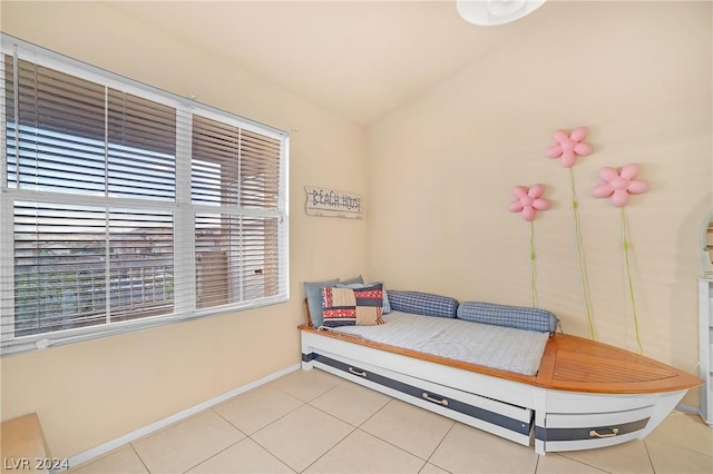 tiled bedroom featuring lofted ceiling