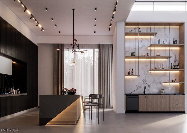 bar featuring sink and hanging light fixtures