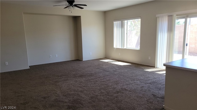 carpeted empty room featuring ceiling fan