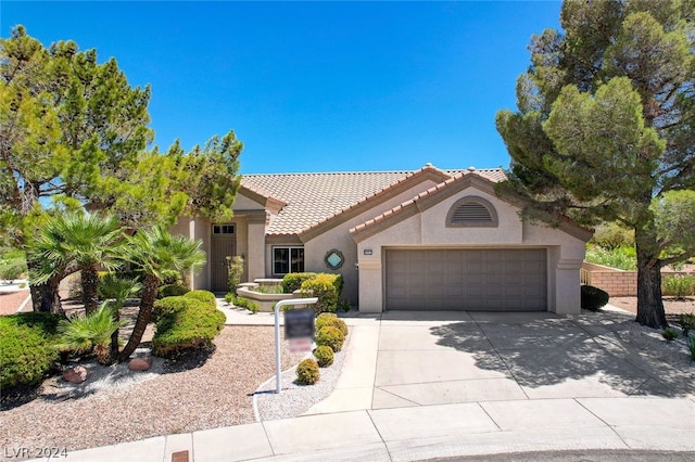 mediterranean / spanish-style home with a garage