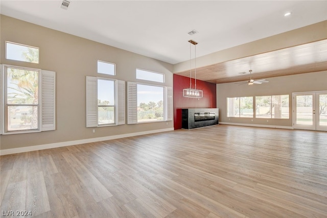 unfurnished living room with light hardwood / wood-style floors and ceiling fan