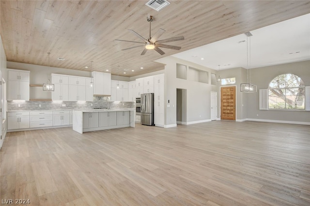 kitchen with stainless steel fridge, light hardwood / wood-style floors, and white cabinetry