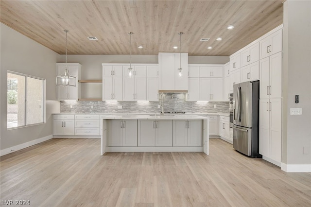 kitchen featuring light wood-type flooring, pendant lighting, wooden ceiling, white cabinetry, and stainless steel refrigerator