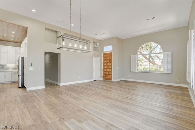 unfurnished living room featuring light hardwood / wood-style floors