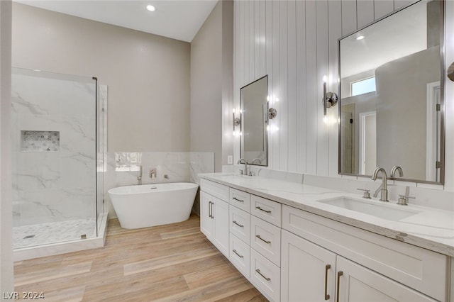 bathroom featuring vanity, hardwood / wood-style flooring, and independent shower and bath