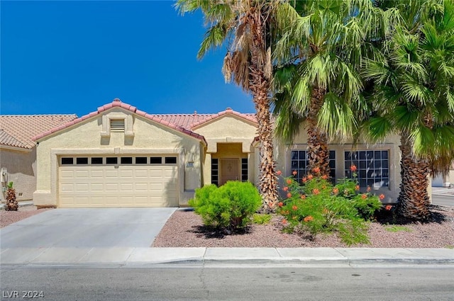 mediterranean / spanish-style house featuring a garage