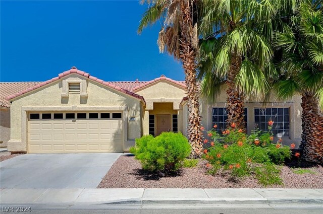 mediterranean / spanish-style house with a garage