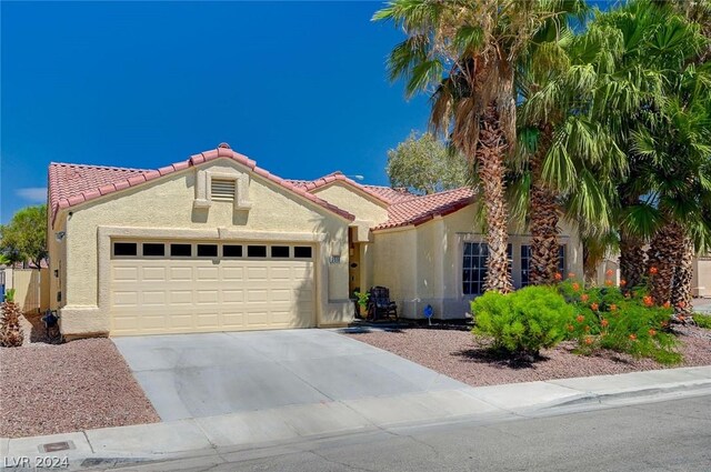 mediterranean / spanish-style home with a garage