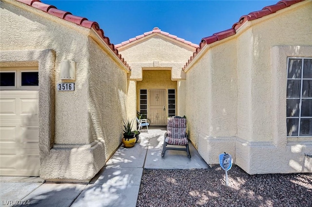 view of exterior entry with a garage