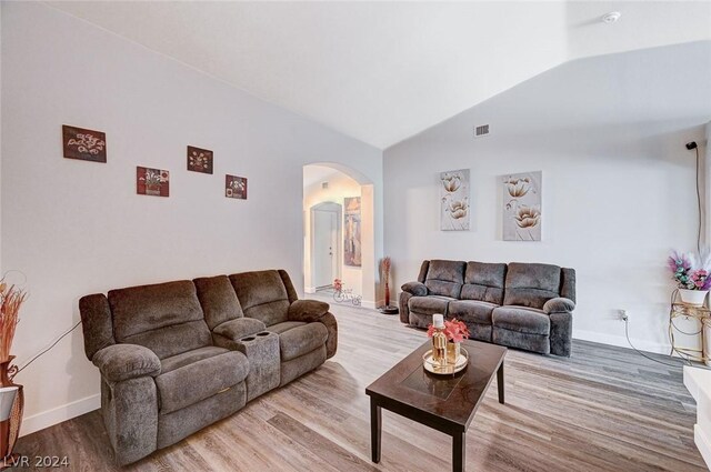 living room with lofted ceiling and light wood-type flooring